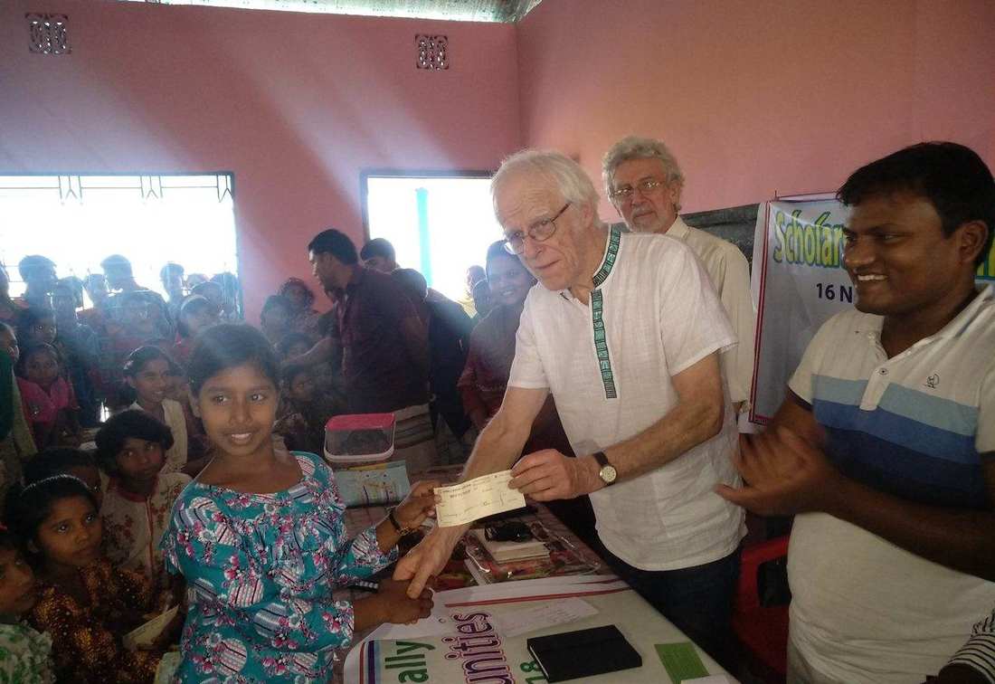 A girl receiving her scholarship cheque at the OfP Scholarship for Girls event